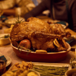 Cozy autumn Thanksgiving table with pumpkins, candles, and festive foods in warm seasonal colours.